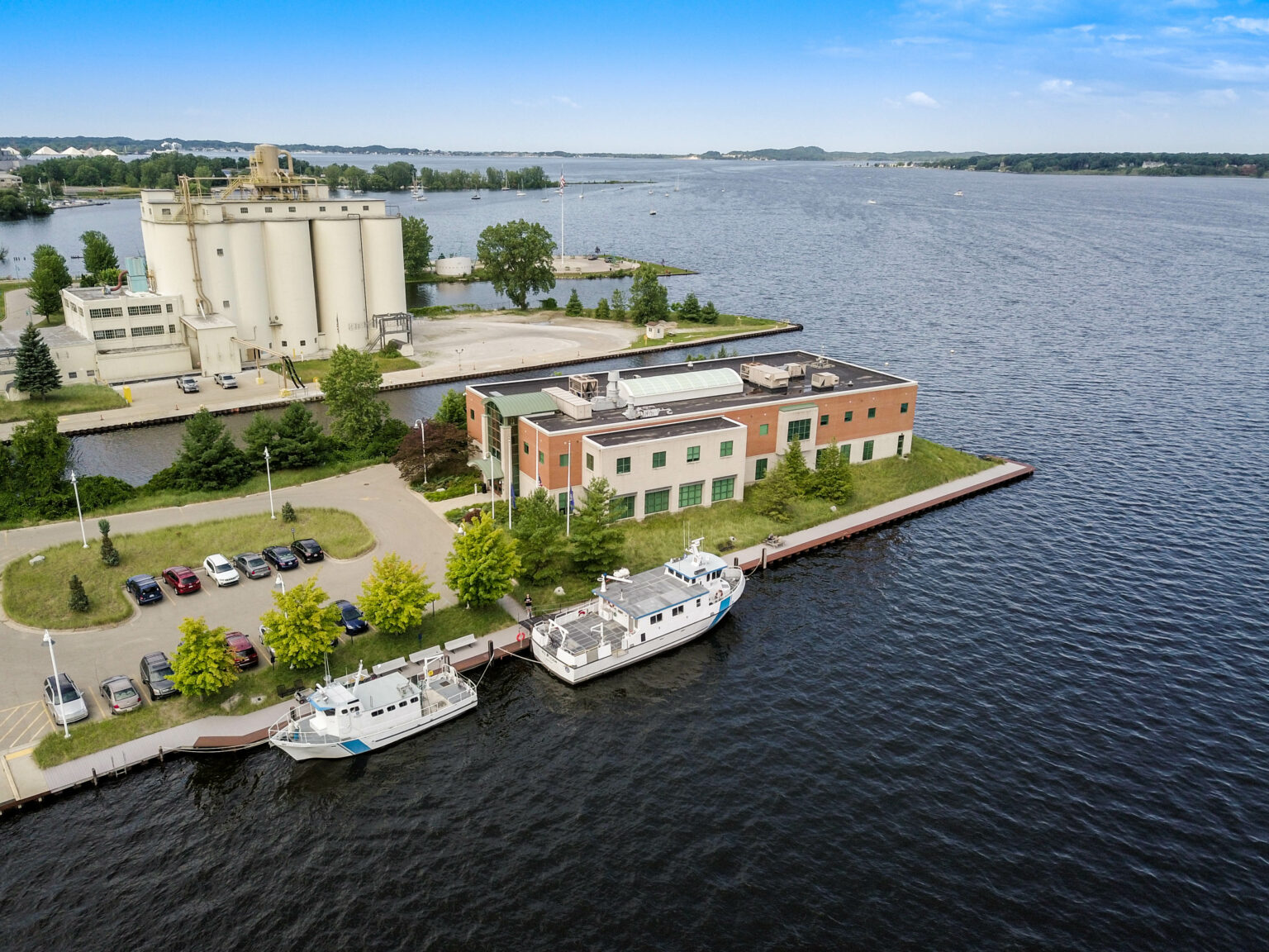 Aerial view of GVSU Annis Wster Resources Institute alongside a lake.