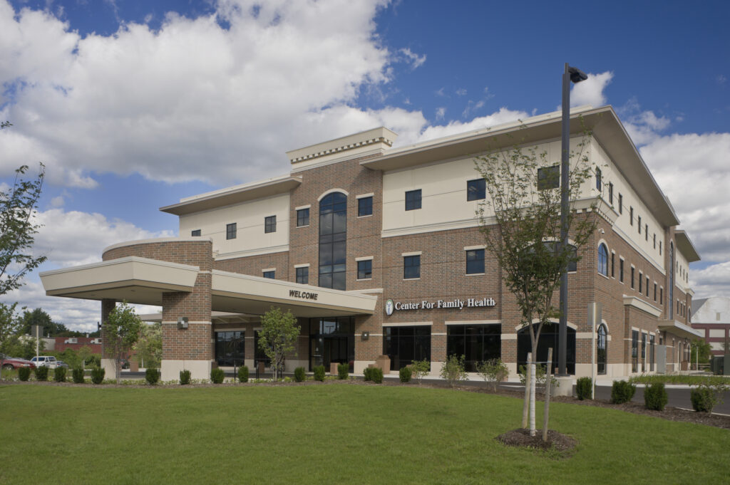 Exterior of the Center For Family Health, a large multi-story brick commercial building.