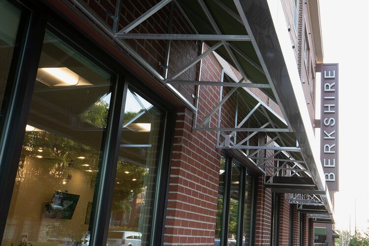 Exterior of a large brick senior living facility. A sign along the side reads "Berkshire."