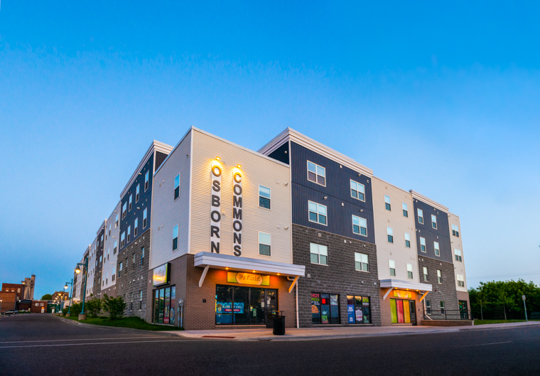 Street view of apartment building named Osborn Commons during evening hours in downtown Sue Ste Marie, Michigan