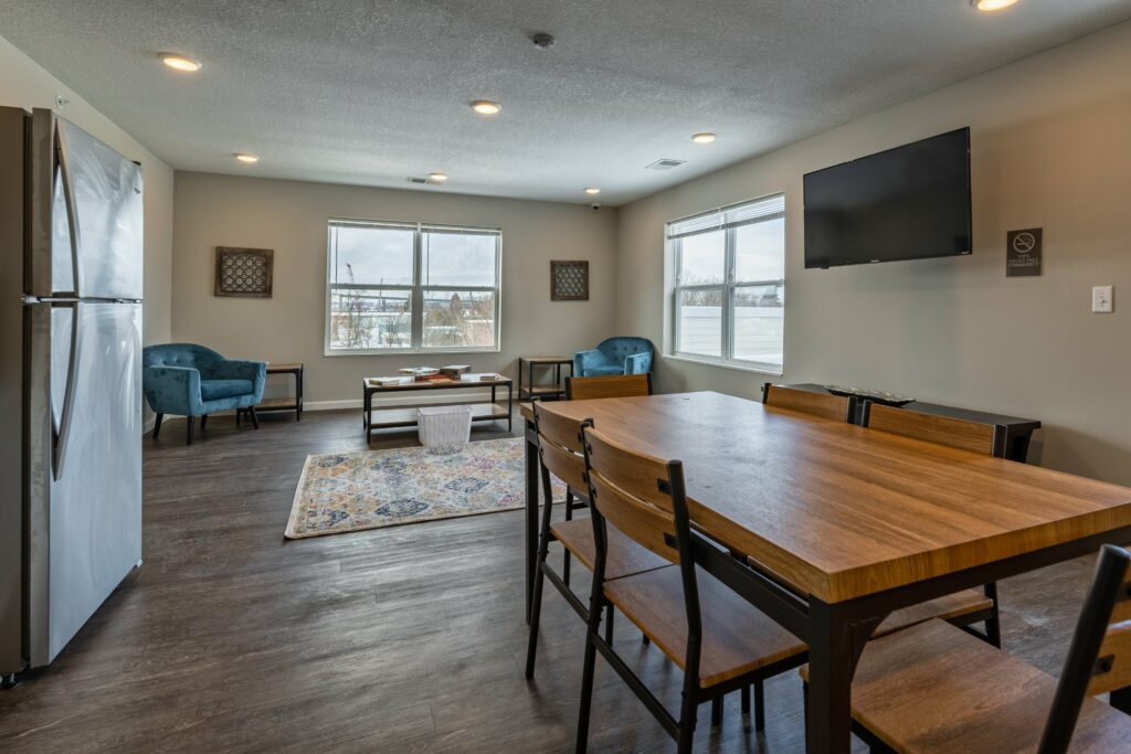 Open-concept living room and kitchen in an Osborn Commons apartment unit